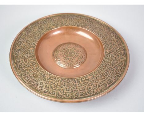 A Heavy Islamic Copper Bowl with Intricate Decoration and a Mother of Pearl Button Under, 75cms Diameter