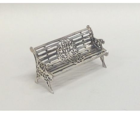 A silver model of a garden bench with slats. Approx. 20 grams. Est. £20 - £30.
