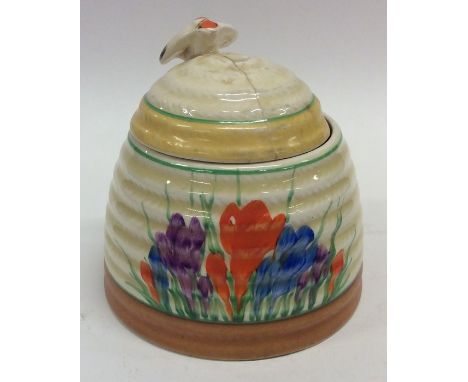 A Clarice Cliff 'Crocus' pattern honey pot decorated in bright colours. Est. £30 - £50.
