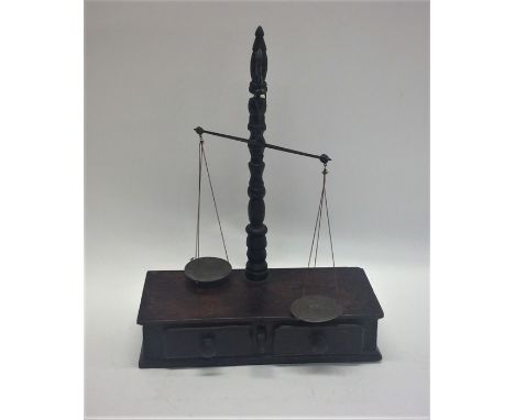 A set of mahogany pan scales together with weights. Est. £30 - £50.