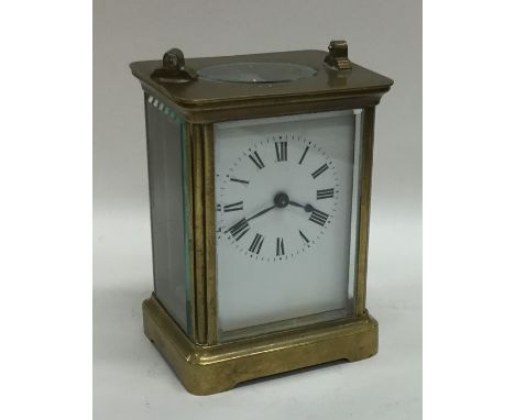 A small brass mounted carriage clock with white enamelled dial. Est. £20 - £30.
