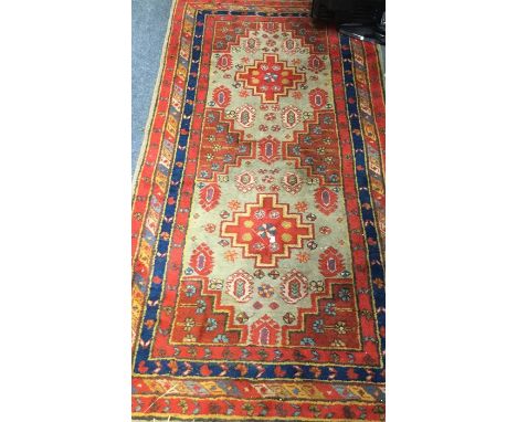 An Antique tapestry Oriental rug in bright colours. Est. £50 - £80.