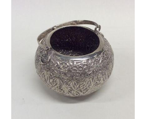 A large circular silver cylindrical caddy with swing handle. Approx. 110 grams. Est. £60 - £80.