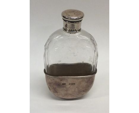 An oval silver mounted handbag flask with gilded interior. London. By HTB. Approx. 183 grams. Est. £80 - £120.