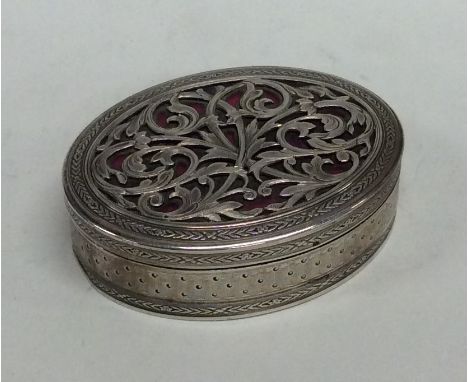 An oval silver box attractively decorated with scrolls and flowers with pink enamel and gilt interior. Approx. 47 grams. Est.