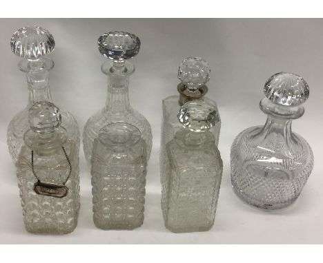 A silver mounted glass decanter together with six others. Est. £20 - £30.