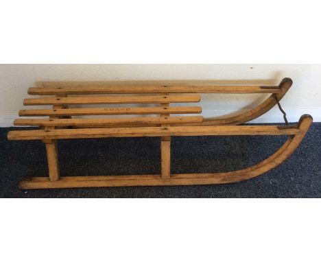 An old wooden sledge. Est. £25 - £35.