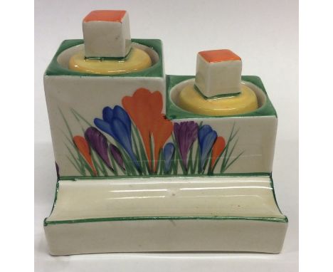 An unusual Clarice Cliff 'Crocus' pattern inkwell with lift-off lids and pen well. Est. £80 - £120.