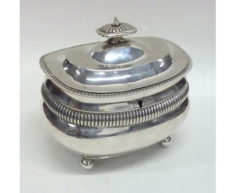 A Georgian silver boat shaped tea caddy with fluted decoration on ball feet. London 1811. By TD. Approx. 555 grams. Est. £800
