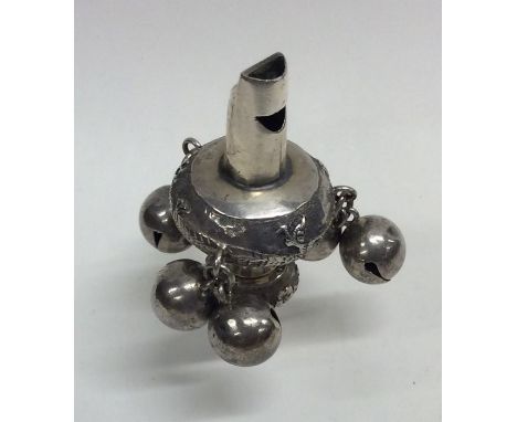 A heavy Chinese silver rattle decorated with bells and figures. Approx. 41 grams. Est. £80 - £120.
