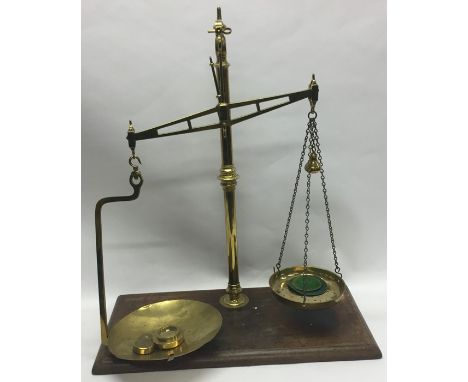 A pair of large heavy brass mounted kitchen scales. Est. £60 - £80.