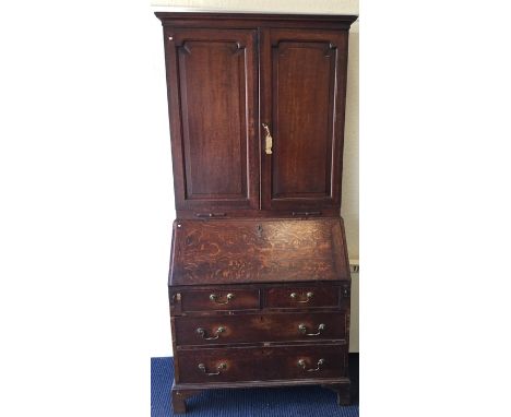 A Georgian oak bureau / bookcase on bracket feet to fitted interior with panelled front. Est. £100 - £200.
