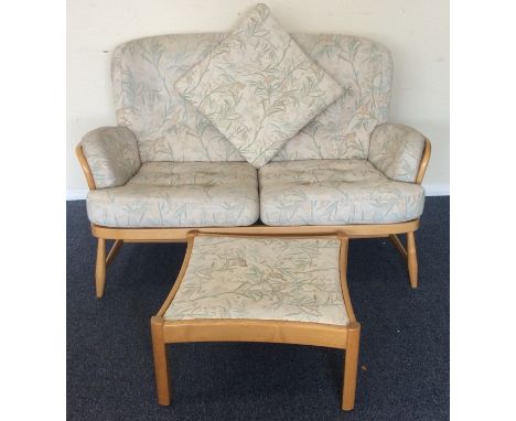 ERCOL: A two seater settee together with matching stool. Est. £80 - £120.