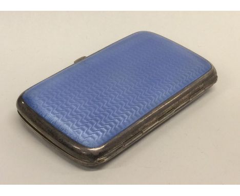 A silver and enamel card case with gilt interior. Bearing import marks. Approx. 90 grams. Est. £120 - £150.