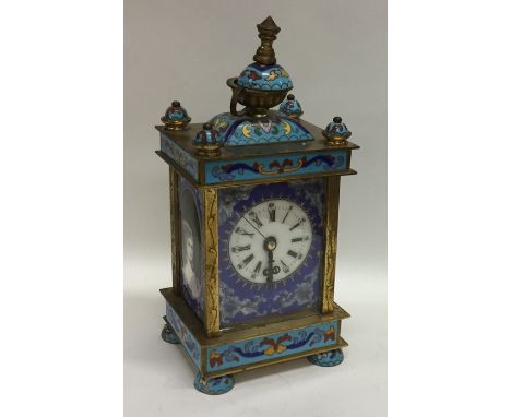 A brass mounted and enamelled carriage clock decorated in blue with white enamelled dial. Est. £80 - £120.