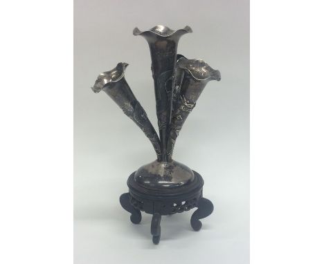 A Chinese silver four trumpet epergne on hardwood stand. Approx. 22 cms high. Approx. 252 grams. Est. £250 - £350.