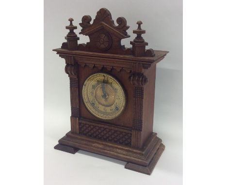 An Edwardian mahogany mantle clock with brass mounted dial. Est. £20 - £30.