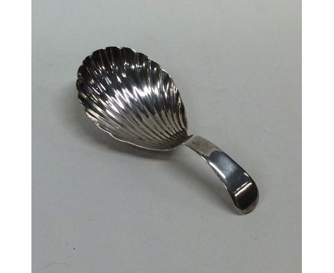 A Georgian silver caddy spoon with fluted bowl. London. By SF. Approx. 10 grams. Est. £25 - £35.