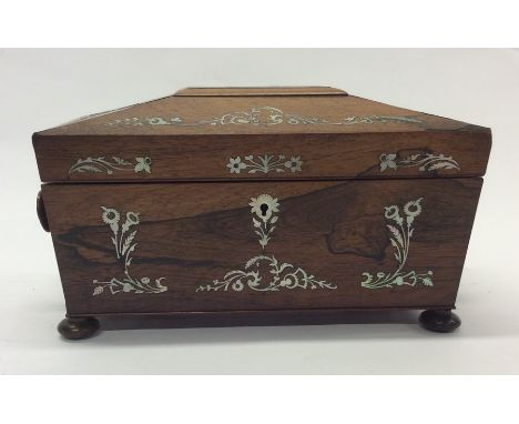 A rosewood and MOP tea caddy with fitted interior. Est. £30 - £50.