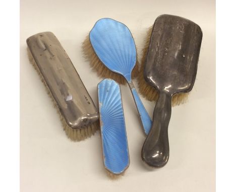 A silver and enamel brush together with other silver brushes. Approx. 410 grams. Est. £20 - £30.