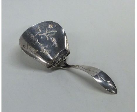 A Dutch silver bright cut caddy spoon of tapering form. Approx. 8.3 grams. Est. £30 - £50.