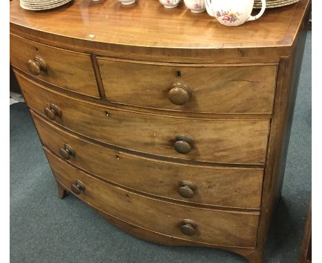 A mahogany bow front chest of five drawers on bracket supports. Est. £50 - £80.