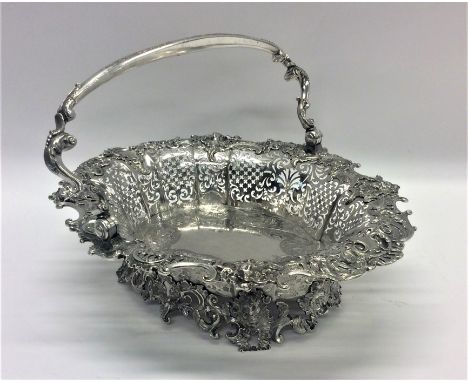 A good quality cast silver George II swing handled basket attractively decorated with figures, scrolls and leaves to bracket 