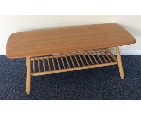 ERCOL: A small occasional table on tapering supports. Est. £30 - £50.