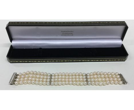 A good quality pearl four strand bracelet with platinum eight stone concealed clasp. Approx. 46 grams. Est. £500 - £800