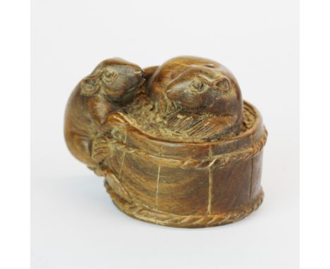 A signed carved fruitwood netsuke of two mice on a small barrell, 4.5cm.