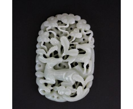 A finely carved Chinese celadon jade panel, probably originally on the top of a box, decorated with two deer among trees, 8 x