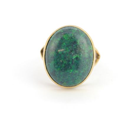 A yellow metal ring (tested minimum 9ct gold) set with a large oval cabochon sugar opal, stone size 2 x 1.5cm, (Q.5).