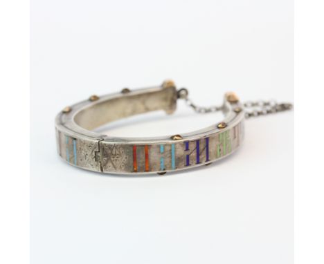 A Russian .88 silver and gilt enamelled hinged horse shoe bangle, H. 6.5cm. Slightly A/F.