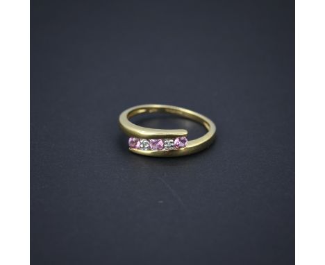 A 9ct yellow gold pink sapphire and diamond ring, (J.5).