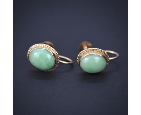 A boxed pair of 9ct yellow gold jade set earrings, L. 2.2cm. With screw backs.