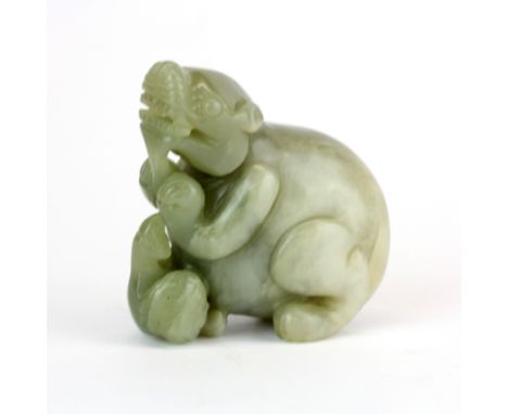 A Chinese carved jade figure of a young dragon with a bird, H. 6cm.