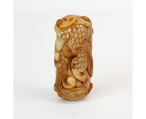 A Chinese carved russet jade amulet of a young dragon wrapped around a rock, L. 7.5cm.