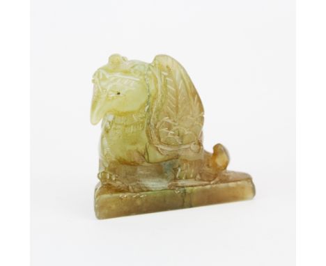 An interesting Chinese carved jade figure of a mythical bird on a triangular base, H. 4cm.