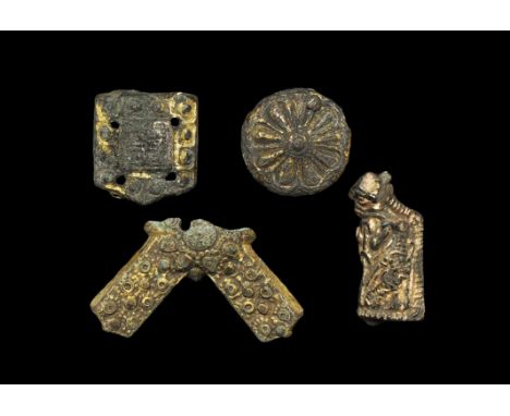 9th-12th century AD. A mixed group of gilt-bronze appliqués comprising: one a domed disc with rosette motif; one D-shaped wit