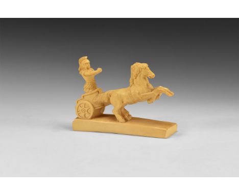 Mid 20th century AD. A composition figure of a Roman soldier wearing cuirass and helmet, standing in a chariot pulled by two 
