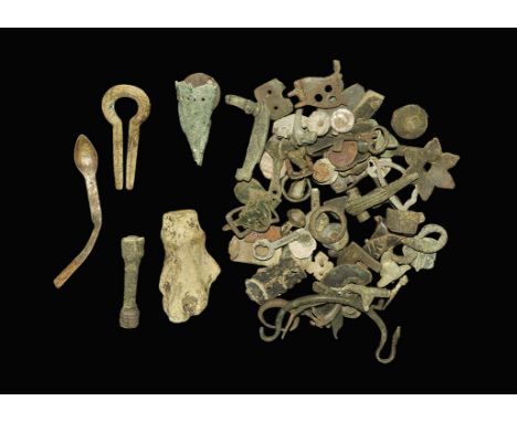 1st-16th century AD. A mixed group of bronze artefacts of various dates including a group of Roman bow brooches, a helmet sus