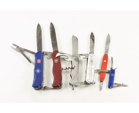 20th century AD. A mixed group of folding pocket knives comprising: one with red scales, large locking knife blade, two bottl