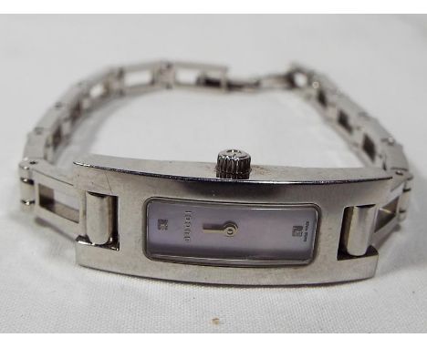 A lady's designer Gucci wristwatch with white metal strap, mother of pearl fascia stone set with two diamond chips, No.3900 L