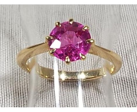 A lady's yellow metal ring set with central ruby coloured stone, possibly Continental, approx weight 2.68grams (all in ) size