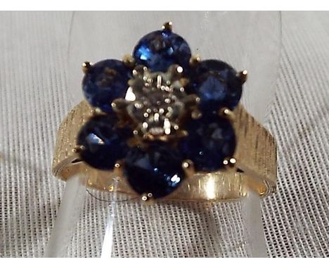 A lady's 9ct yellow gold sapphire and illusion set diamond cluster, approx weight 2.93 grams (all in) size M and a half, Est 