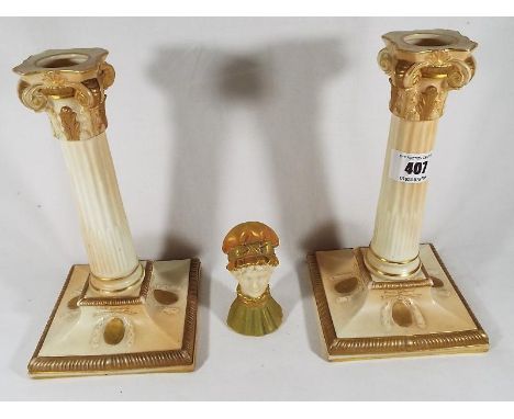 A pair of early 20th century Royal Worcester candlesticks, shape No. 3/10, 20.5cm (h) and a Royal Worcester candle snuffer in