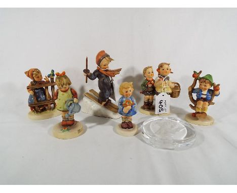 Six Goebel Hummel figurines and a glass paperweight (7)