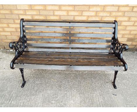 A cast iron garden bench with wooden slats 73cm x 127cm x 58cm