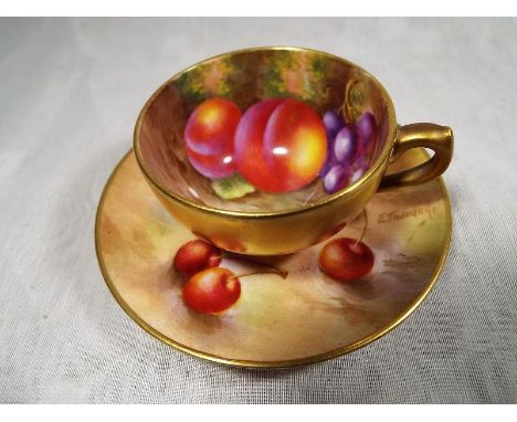 A Royal Worcester cup and saucer set hand painted with fallen fruits, the cup signed H Ayrton, the saucer signed E Townsend -