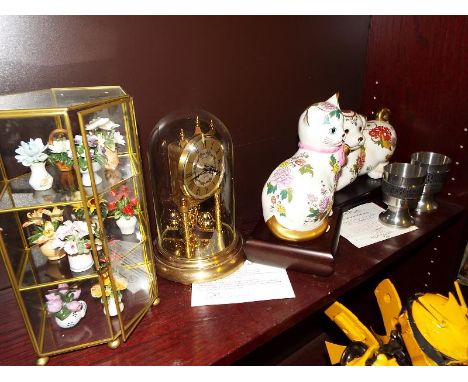 Two feline figurines by Franklin Mint entitled The Royal Kitten of Prosperity with certificates, an Estyma anniversary clock 